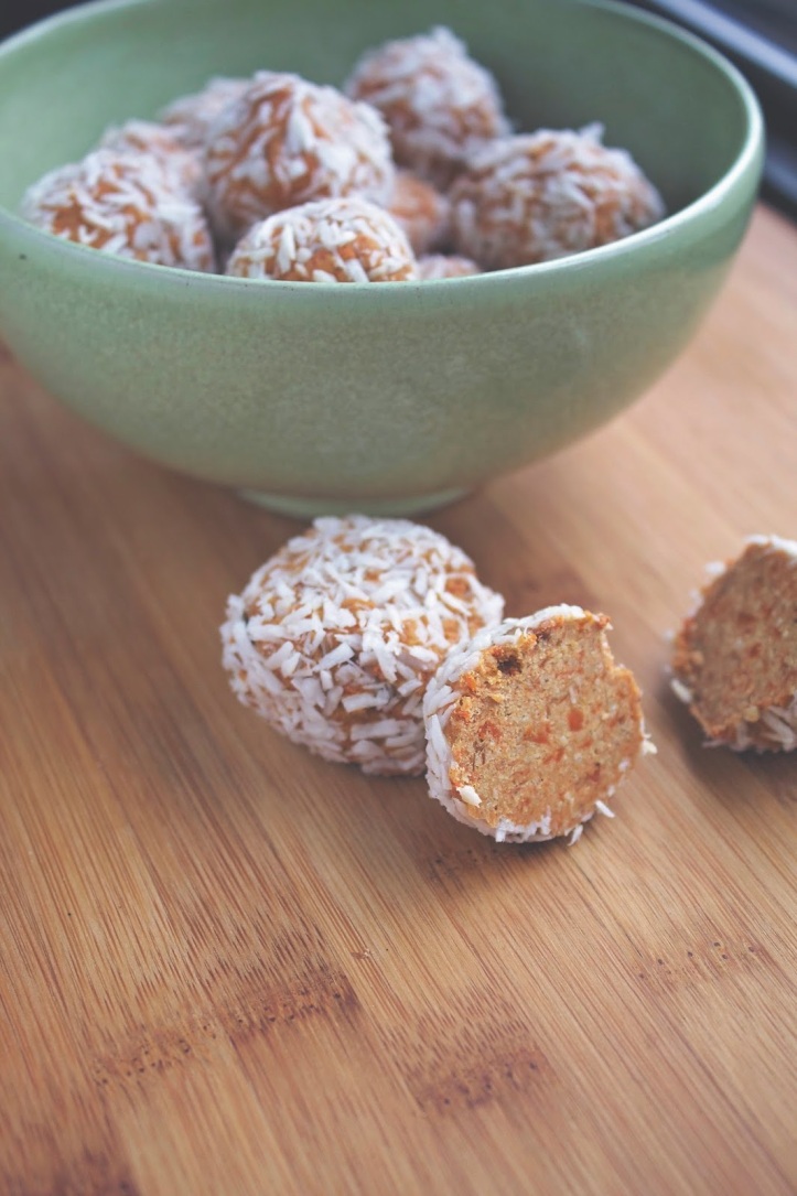 Bowl of carrot truffle balls on a wooden counter